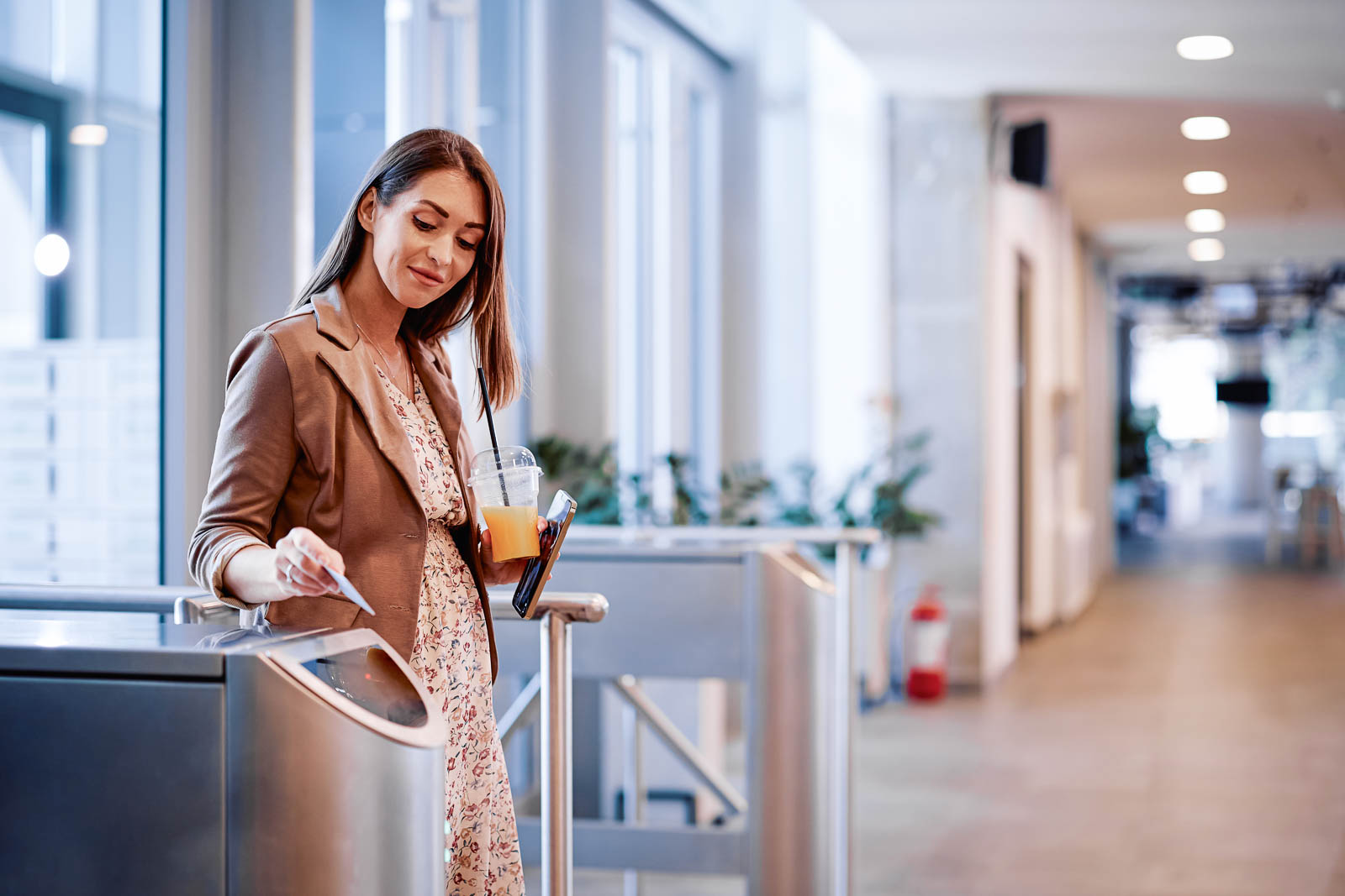 Female entrepreneur using using access card while entering the office building.